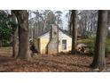 View of back of home, showing brick chimney and home exterior at 4622 Dogwood Rd, Pine Lake, GA 30072