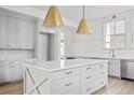 Spacious kitchen featuring a large center island with white countertop, gray cabinetry, and stainless steel appliances at 100 Sheridan Dr, Atlanta, GA 30305