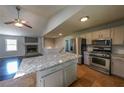 Modern kitchen features stainless steel appliances, an island with marble counters and tile floors at 180 Old Airport Rd, Carrollton, GA 30116