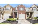 Well-maintained townhome with brick and siding, showcasing a one-car garage and landscaped front yard at 3364 Thornbridge Dr # 0, Powder Springs, GA 30127