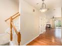 Inviting hallway with hardwood floors, staircase, and view into a cozy living room with a fireplace at 3364 Thornbridge Dr # 0, Powder Springs, GA 30127