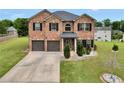 Charming two-story brick home with a well-manicured lawn and a two-car garage at 85 Foxgrove Cv, Covington, GA 30014
