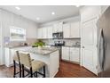 Bright kitchen featuring granite countertops, stainless steel appliances, a convenient island, and white cabinetry at , Atlanta, GA 30318