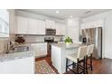 Modern kitchen features granite countertops, stainless steel appliances, and a center island with bar seating at , Atlanta, GA 30318