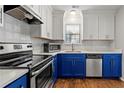 Bright kitchen featuring white cabinets, stainless steel appliances and blue accent cabinets at 2300 Newport Lndg, Atlanta, GA 30009