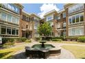 Classic brick apartment building with a central water fountain and manicured landscaping at 272 14Th St # 23, Atlanta, GA 30309