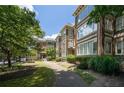 Elegant brick apartment building with lush landscaping and inviting entrance at 272 14Th St # 23, Atlanta, GA 30309