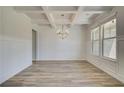 Bright dining room features a coffered ceiling, wainscoting, and wood-look floors at 2780 Dolce Rd, Dacula, GA 30019
