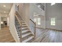 Spacious foyer with staircase, wood-look floors, wainscoting, and views to other rooms at 2780 Dolce Rd, Dacula, GA 30019