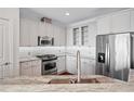Modern kitchen with stainless steel appliances, granite countertops, and white cabinetry at 2950 Mount Wilkinson Se Pkwy # 505, Atlanta, GA 30339