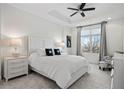 Comfortable bedroom with soft carpet, tray ceilings, and ample natural light at 2950 Mount Wilkinson Se Pkwy # 505, Atlanta, GA 30339
