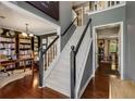 Inviting foyer showcasing a staircase leading upstairs, hardwood floors, and access to the library at 5404 Trumpet Vine Se Trl, Mableton, GA 30126