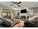 Cozy living room featuring a fireplace, ceiling fan, and comfortable seating, perfect for relaxing or entertaining at 5404 Trumpet Vine Se Trl, Mableton, GA 30126