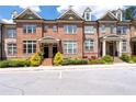 Attractive brick townhome featuring a well-maintained lawn and a welcoming entrance at 1222 Lavista Ne Cir, Atlanta, GA 30324