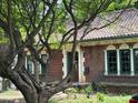 Quaint brick house with a red tile roof, green trim, and a lovely arched entryway and front yard at 1225 Cameron Ne Ct, Atlanta, GA 30306