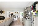Welcoming entryway showcases wood floors, stylish decor, and a glimpse into the adjacent kitchen and dining area at 1430 Mineral Springs Rd, Hoschton, GA 30548