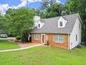 Beautiful brick home featuring shutters, dormers, manicured lawn, and inviting walkway at 2458 Zachary Woods Dr, Marietta, GA 30064