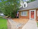 Close up of the brick house with landscaped front yard and a walkway at 2458 Zachary Woods Dr, Marietta, GA 30064
