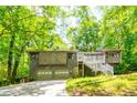 A unique home featuring a two-car garage, distinctive architectural elements and a quaint deck at 2738 Westminister Nw Ln, Conyers, GA 30012