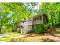 Charming home featuring a stairway to the entrance and unique architectural details at 2738 Westminister Nw Ln, Conyers, GA 30012