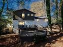 Backyard featuring a wooden deck, stairs, and mature trees, creating a private, shaded outdoor space at 2814 Lloyd Rd, Decatur, GA 30034
