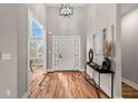 Grand entryway boasts soaring ceilings, stylish light fixtures, and beautiful hardwood floors, creating a welcoming ambiance at 939 Whistler Ln, Canton, GA 30114