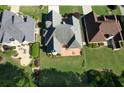 Aerial view of backyard including patio with table and chairs and well-landscaped yard at 940 River Valley Dr, Dacula, GA 30019