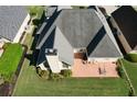 Aerial view of backyard including patio with table and chairs in a well-landscaped yard at 940 River Valley Dr, Dacula, GA 30019