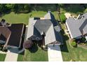 Aerial view of a beautiful brick home with a well-manicured lawn and a two-car garage at 940 River Valley Dr, Dacula, GA 30019
