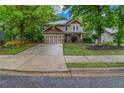 Charming two-story home featuring a well-maintained lawn and a spacious two-car garage at 1714 Boulder Walk Se Ln, Atlanta, GA 30316