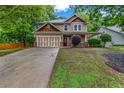 Charming two-story home featuring a well-maintained lawn and a spacious two-car garage at 1714 Boulder Walk Se Ln, Atlanta, GA 30316