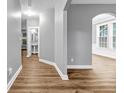 Inviting hallway with hardwood floors leading to powder room and a bright, windowed dining area at 1714 Boulder Walk Se Ln, Atlanta, GA 30316