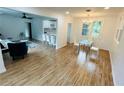 Bright and airy living room featuring wood floors and a modern open layout with a dining area at 1766 Venetian Sw Dr, Atlanta, GA 30311