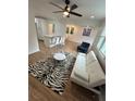 Open concept living space with modern decor, including a zebra rug and white sofa at 1766 Venetian Sw Dr, Atlanta, GA 30311