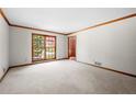 Bright living room with carpet, wood trim, and a large window at 227 Eton Ct, Mableton, GA 30126