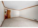 Neutral living room with carpet, wood trim, and an open doorway at 227 Eton Ct, Mableton, GA 30126