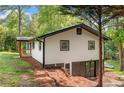 Back exterior showcasing the walk-out basement and a newly stained deck overlooking the expansive wooded backyard at 474 Upper Burris Rd, Canton, GA 30114