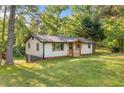 View of renovated home with walk-out basement, natural light, and spacious front lawn with mature trees at 474 Upper Burris Rd, Canton, GA 30114