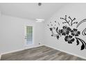 Stylish bedroom featuring modern lighting, vinyl floors, and a door to the patio at 6625 Peppermill Ln, South Fulton, GA 30349