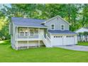 Charming two-story home with a well-maintained lawn and an attached two-car garage at 6625 Peppermill Ln, South Fulton, GA 30349
