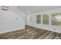 Bright living room with luxury vinyl plank floors and three sunny windows at 6625 Peppermill Ln, South Fulton, GA 30349