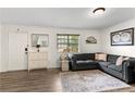 Cozy living area featuring hardwood floors, grey sofa, and lots of natural light at 6900 Roswell Rd # 3N, Atlanta, GA 30328