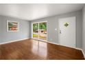 Bright living room featuring hardwood floors and large windows with natural light at 765 Shellnut Dr, Forest Park, GA 30297