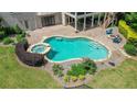 Backyard pool with a stone surround, a hot tub, beautiful landscaping and an outdoor fire pit with chairs at 100 Braxton Way, Roswell, GA 30075