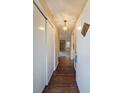 Inviting foyer with hardwood floors, stylish light fixture, and views of the living room with fireplace at 1003 Wiley Bridge Rd, Woodstock, GA 30188