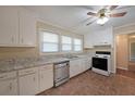 Functional kitchen with white cabinetry, faux marble countertops, and stainless steel dishwasher at 1003 Wiley Bridge Rd, Woodstock, GA 30188