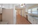 Bright kitchen featuring white cabinets, stainless steel appliances, and durable tile flooring at 1003 Wiley Bridge Rd, Woodstock, GA 30188