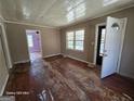 View of the interior of a home with peeling wood floors, white trim, and beige colored walls at 1243 Hill Nw St, Conyers, GA 30012