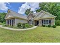 Charming single-Gathering home with stone accents, a landscaped front yard, and a well-maintained lawn at 1815 Sharon Rd, Cumming, GA 30041