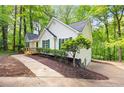 Side view of a well-maintained home featuring green shutters and a cozy deck at 3684 Regent Nw Dr, Kennesaw, GA 30144
